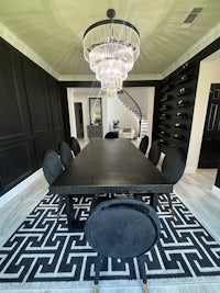 a black and white dining room with a chandelier