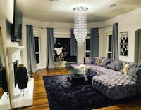 a living room with a fireplace and a chandelier